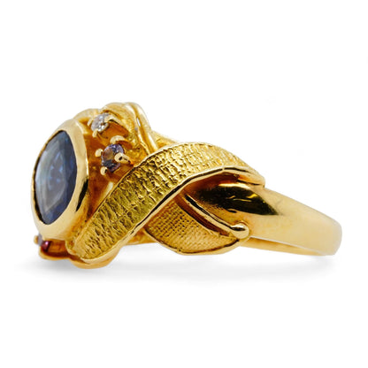 18K Gold Bezel Set Blue Sapphire With Diamond Accents And Leaf Motif Ring