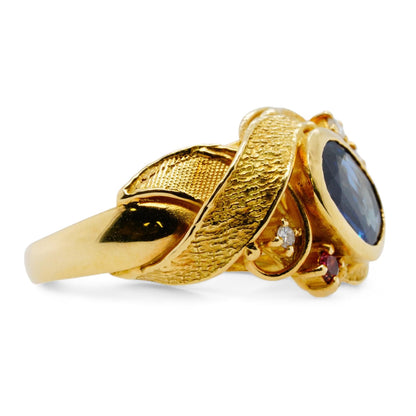 18K Gold Bezel Set Blue Sapphire With Diamond Accents And Leaf Motif Ring