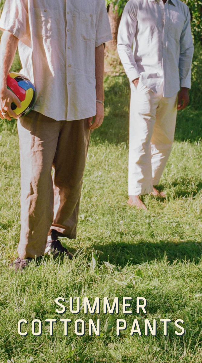 two men in cotton pants standing on grass 