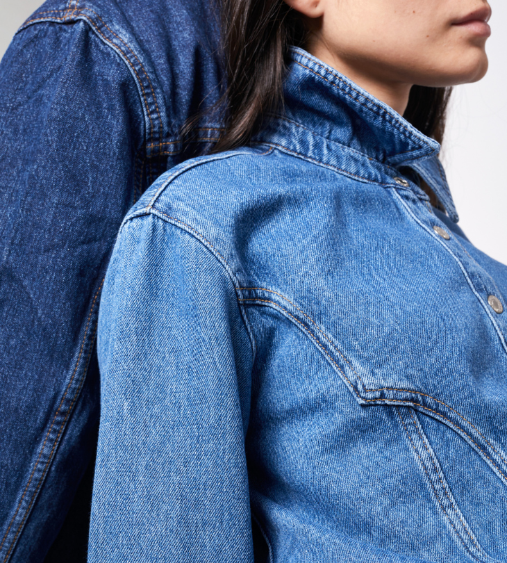 two people wearing denim leaning on each other