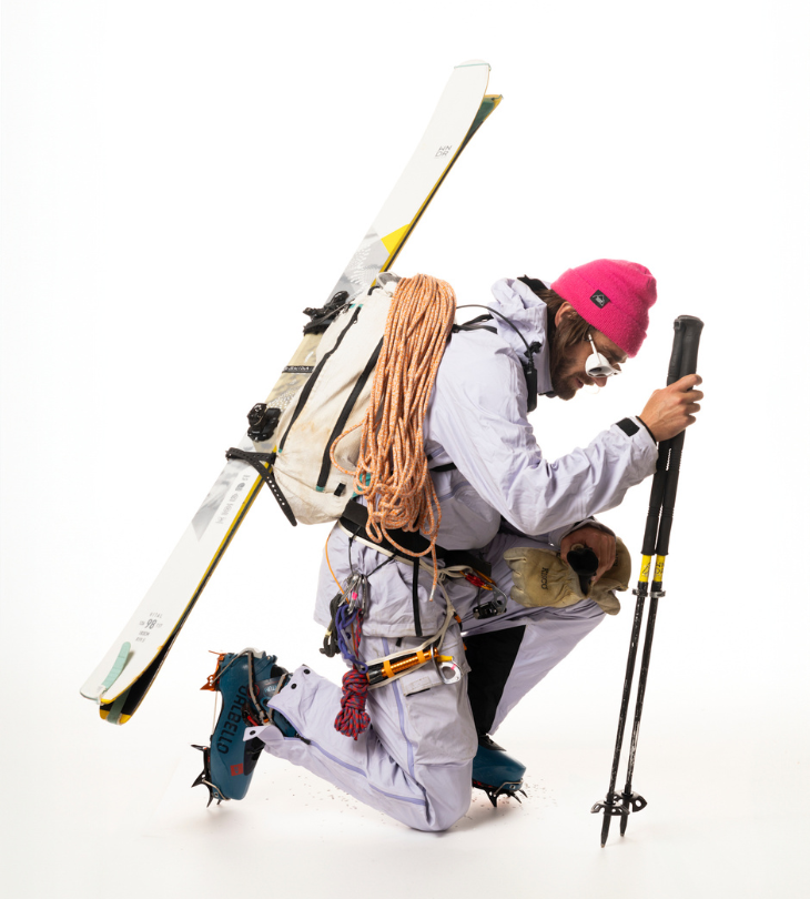 a man kneeling down with ski gears 