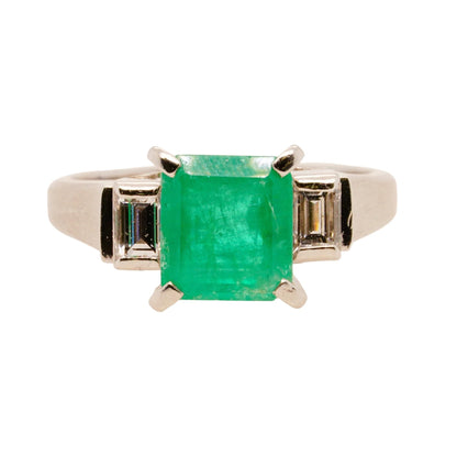 Platinum Princess Shaped Emerald With Side Diamonds Ring