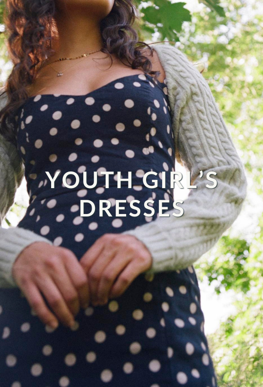 a girl in a navy polka dot dress with caption: "Youth Girl's Dresses"