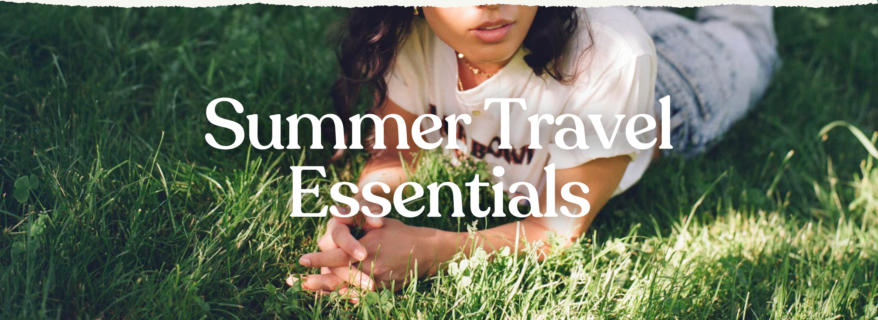 a woman in tshirts and jeans laying on the grass with caption: "Summer Travel Essentials"