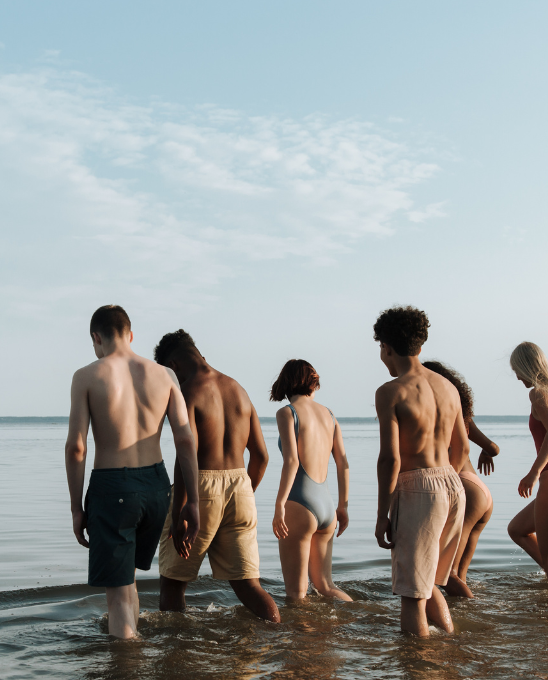 a group of people in swimsuit in the ocean